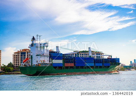 Cargo ship with container in Miami. Container on barge at Port Miami. Cargo ship barge at harbor with container. Cargo ship in Florida. Miami beach with barge in Biscayne bay. Cargo vessel logistics Cargo ship with container in Miami. Container on barge at Port Miami. Cargo ship barge at harbor with container. Cargo ship in Florida. Miami beach with barge in Biscayne bay. Cargo vessel logistics 136442019