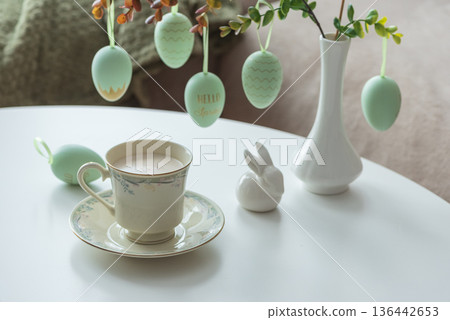 Spring Table Decor with Bunny Figurines, Hanging Eggs and Floral Cup of Coffee Spring Table Decor with Bunny Figurines, Hanging Eggs and Floral Cup of Coffee 136442653