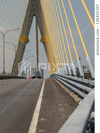 Stretching across the Chao Phraya River, the Rama VIII Bridge is an asymmetrical masterpiece of gold and steel. Stretching across the Chao Phraya River, the Rama VIII Bridge is an asymmetrical masterpiece of gold and steel. 136443167