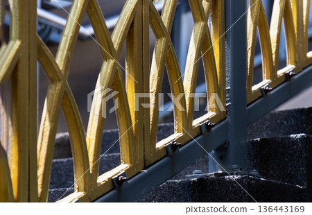 A lattice of interlocking arches, finished in a luminous gold, serves as the centerpiece of this industrial composition. A lattice of interlocking arches, finished in a luminous gold, serves as the centerpiece of this industrial composition. 136443169