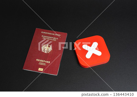 German passport and red refusal symbol. Ban on entry of citizens into the country of arrival. Ban on entry or exit. Refusal to obtain a passport or citizenship. 136443410