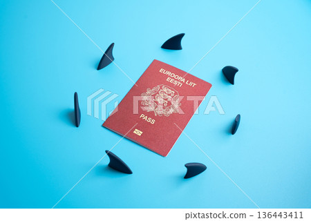 The Estonian passport is surrounded by a circle of shark fins. Legal, financial, and tax obligations that create challenges for expatriates. Immigration law, citizenship analysis, and global mobility The Estonian passport is surrounded by a circle of shark fins. Legal, financial, and tax obligations that create challenges for expatriates. Immigration law, citizenship analysis, and global mobility 136443411