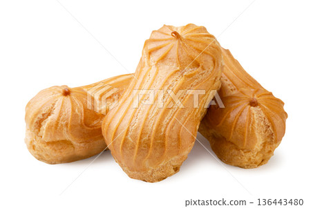 Pile of mini eclairs close-up on a white background. Isolated 136443480