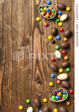 Easter chocolate eggs and colorful candies border Easter chocolate eggs and colorful candies border 136443731