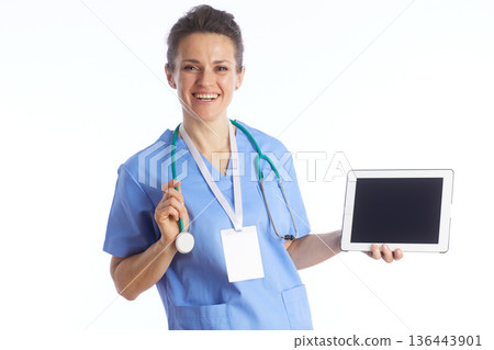 Smiling Physician Holding Tablet Computer in Clinic 136443901