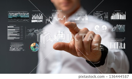 Businessperson uses touch screen to show data growth with digital graphs and icons for marketing analysis and business review 136444587