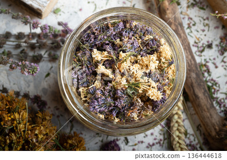 lilac dry flowers in jar at around dry medicine herbs. top view lilac dry flowers in jar at around dry medicine herbs. top view 136444618