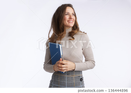 Confident Businesswoman Looking Aside with Blue Notebook Confident Businesswoman Looking Aside with Blue Notebook 136444896