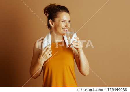 Contented Woman Enjoying Post-Activity Drink 136444988