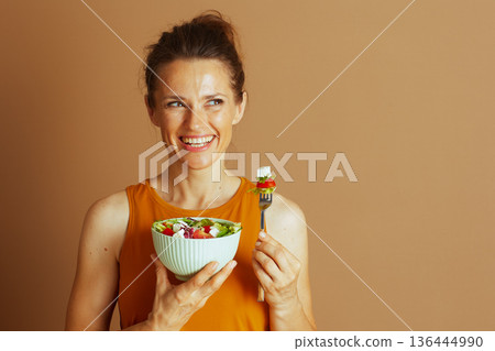 Joyful Woman Embraces a Healthy Salad Meal Joyful Woman Embraces a Healthy Salad Meal 136444990