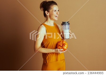 Joyful Autumn Fitness Woman with Blender Bottle Joyful Autumn Fitness Woman with Blender Bottle 136444993