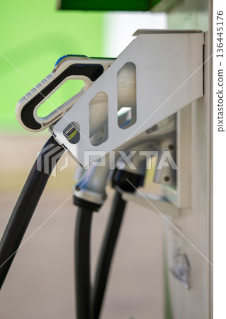 Electric vehicle charging connector at a station Electric vehicle charging connector at a station 136445176