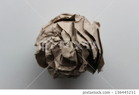 Pulp industry. Used wrapping paper ball isolated on white closeup view  136445231