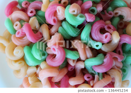 Pattern of colored macaroni with additives from natural vegetable juices stock photo for backgrounds 136445234