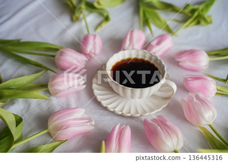 Side View Pink Tulips Around Coffee Cup with Saucer 136445316