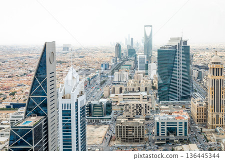 Contemporary cityscape with futuristic high rise architecture, corporate towers and dense urban downtown development representing economic growth, Al Olaya, Riyadh, Saudi Arabia 136445344