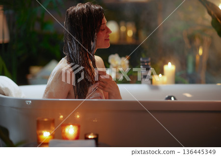 Serene Hair Washing with Suds in a Candlelit Bathtub 136445349