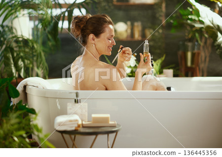 Woman Preparing Skincare Products in a Bathtub 136445356