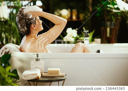 Serene Hair Wash in a Softly Lit, Plant-Filled Bath 136445365