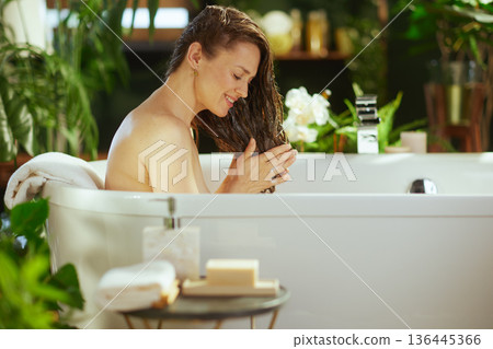 Applying Hair Product in a Relaxing Bathtub Setting Applying Hair Product in a Relaxing Bathtub Setting 136445366