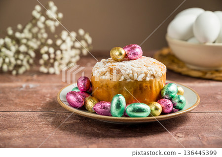 Easter spring holiday background. Cake with chocolate easter eggs, gypsophila flowers Easter spring holiday background. Cake with chocolate easter eggs, gypsophila flowers 136445399