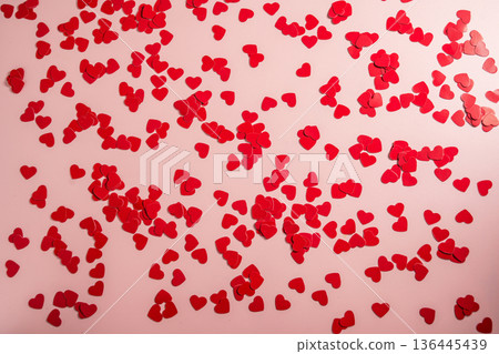 Valentine Day background with red hearts confetti over pink background. St. Valentine's Day love concept, flat lay Valentine Day background with red hearts confetti over pink background. St. Valentine's Day love concept, flat lay 136445439
