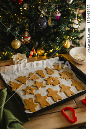 Holiday background. Uncooked raw Christmas gingerbread cookies on baking tray, lifestyle 136445461