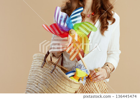 Modern woman in blouse and shorts with windmill toy 136445474