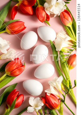 Easter, spring floral background. Red tulips, Fresia and white eggs, flowers on pink background 136445514