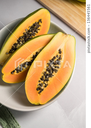 Papaya exotic fruit halves on plate. Healthy vegan food. 136445561