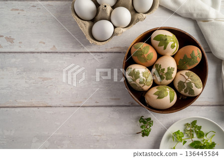 DIY Easter eggs with natural leaves, creating patterns on eggs using plants. Eco friendly colouring easter eggs DIY Easter eggs with natural leaves, creating patterns on eggs using plants. Eco friendly colouring easter eggs 136445584