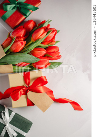 Mothers' day. Red tulips with gift boxes. Easter holiday. Bright background, copy space. 136445603