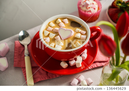 Valentine's Day background. Red cup of coffee with heart shaped marshmallows and ret tulips 136445629