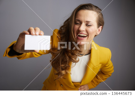 Enthusiastic Professional Offering a Business Card 136445673