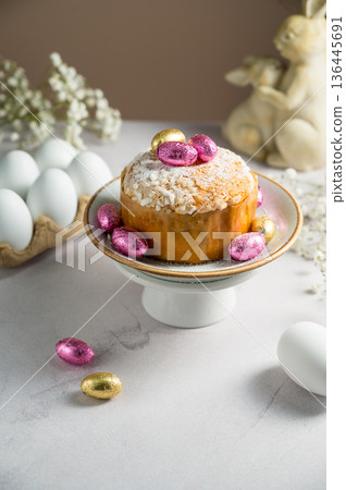Easter spring holiday background. Cake with chocolate easter eggs, gypsophila flowers and bunny Easter spring holiday background. Cake with chocolate easter eggs, gypsophila flowers and bunny 136445691