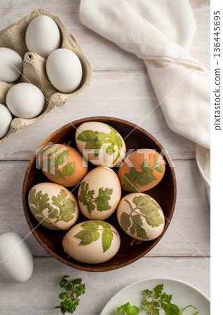 DIY Easter eggs with natural leaves, creating patterns on eggs using plants. Eco friendly colouring easter eggs DIY Easter eggs with natural leaves, creating patterns on eggs using plants. Eco friendly colouring easter eggs 136445695