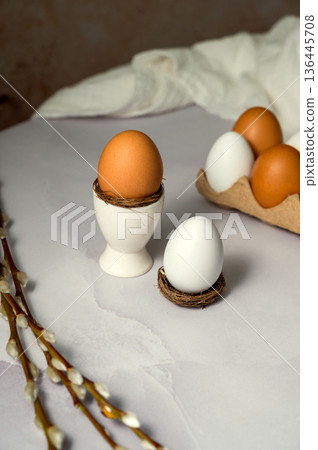Easter spring background. Egg in ceramic egg holder, with willow pussy branch. Minimalistic Easter spring background. Egg in ceramic egg holder, with willow pussy branch. Minimalistic 136445708