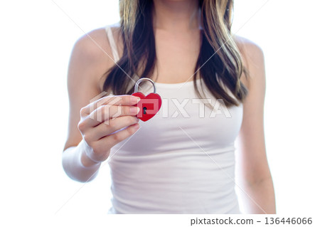 Woman holding a heart-shaped key. Mental health, mental illness, psychosomatic medicine, psychiatric hospital, mental health. Woman holding a heart-shaped key. Mental health, mental illness, psychosomatic medicine, psychiatric hospital, mental health. 136446066