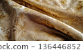 Luxurious deep gold velvet texture background with soft lighting and rich fabric folds. 136446852