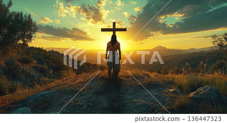 View of Jesus Christ on the cross under a dramatic sunset on a distant hill. Header banner mockup with copy space. 136447323