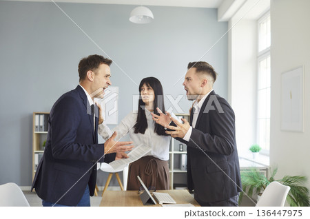 Office conflict between businessmen while teammate mediates heated argument Office conflict between businessmen while teammate mediates heated argument 136447975