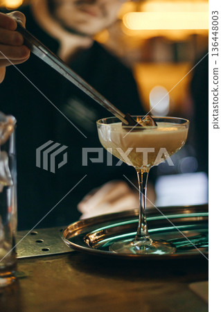 Bartender Serving Porn Star Martini Cocktail In Coupe Glass With Passion Fruit Bartender Serving Porn Star Martini Cocktail In Coupe Glass With Passion Fruit 136448003