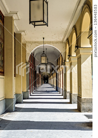 Promenade with long arcade columns surrounding Hofgarten Park in Munich, Germany 136448583
