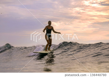 Active Lifestyle Depicted Through Focused Surfing Balance Exercise In Daylight Active Lifestyle Depicted Through Focused Surfing Balance Exercise In Daylight 136448780