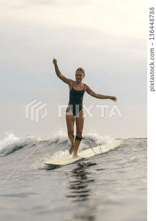Stylish Woman By Ocean, Sunset Scene With Poised Ocean Figure Stylish Woman By Ocean, Sunset Scene With Poised Ocean Figure 136448788