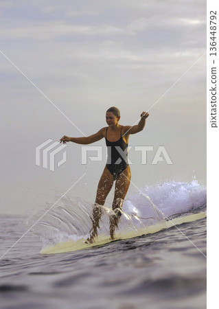 Active Lifestyle Depicted Through Focused Surfing Balance Exercise In Daylight Active Lifestyle Depicted Through Focused Surfing Balance Exercise In Daylight 136448792