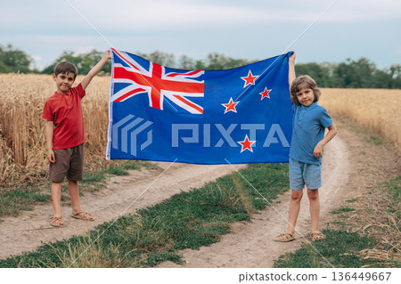 Happy New Zealander Children With New Zealand Flag Outdoors In Wheat Field Happy New Zealander Children With New Zealand Flag Outdoors In Wheat Field 136449667