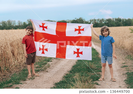 Little Boys Stands Georgian Flag - Rural Road, Summer Countryside, Sakartvelo Little Boys Stands Georgian Flag - Rural Road, Summer Countryside, Sakartvelo 136449700