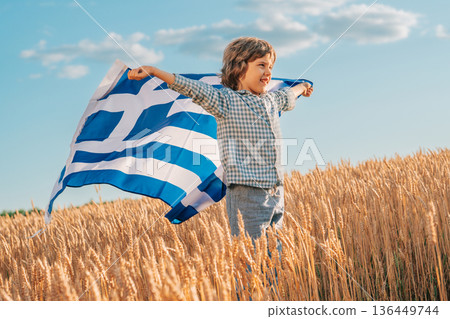 Patriot Boy Standing Wheat Field Holding Greek Hellas Flag In The Wind, Homeland Patriot Boy Standing Wheat Field Holding Greek Hellas Flag In The Wind, Homeland 136449744