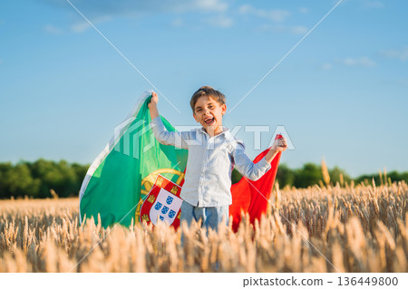 Patriot Little Boy Holding Portuguese Flag In Wheat Field, Symbolizing Pride Patriot Little Boy Holding Portuguese Flag In Wheat Field, Symbolizing Pride 136449800